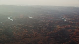 5.5K aerial stock footage of flying by the Colorado River in Meander Canyon, Canyonlands National Park, Utah, sunset Aerial Stock Footage | AX138_340