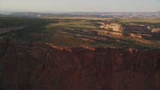 5.5K aerial stock footage approach and fly over dirt road near rock formations on Hatch Point, Moab, Utah, sunset Aerial Stock Footage | AX138_350E