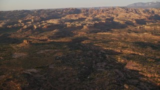 5.5K aerial stock footage of flying toward desert rock formations, Moab, Utah, sunset Aerial Stock Footage | AX138_366E