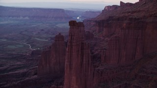 5.5K aerial stock footage of flying over The Titan, Echo Tower, approaching Ancient Art, Fisher Towers, Utah, twilight Aerial Stock Footage | AX138_444E