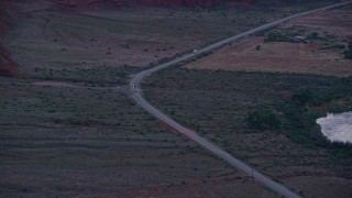 5.5K aerial stock footage track SUV, two sedans on State Route 128, Moab, Utah, twilight Aerial Stock Footage | AX138_457E