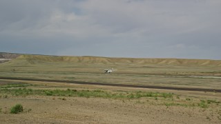 AX139_019 - 5.5K aerial stock footage of tracking Tecnam P2006T taking off from runway, Canyonlands Field, Utah