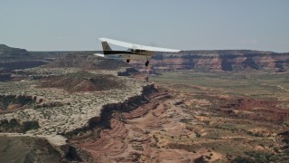 5.5K aerial stock footage of tracking Cessna flying over desert in Grand County, Utah Aerial Stock Footage | AX139_026E