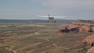 5.5K aerial stock footage of a Cessna over desert approaching rock formations, Grand County, Utah Aerial Stock Footage | AX139_028E