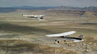 5.5K aerial stock footage of air to air view of Tecnam P2006T and Cessna flying over desert, Grand County, Utah Aerial Stock Footage | AX139_084E