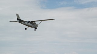 AX139_122 - 5.5K aerial stock footage of tracking Cessna flying high above desert, Emery County, Utah