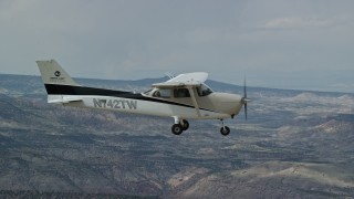 5.5K aerial stock footage of a view of a Cessna over desert mountains, seen from above, Carbon County, Utah Aerial Stock Footage | AX139_146E