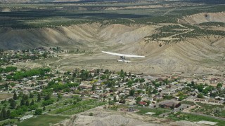 5.5K aerial stock footage of tracking a Cessna airplane over desert, approaching distant mountains, Carbon County, Utah Aerial Stock Footage | AX140_005E