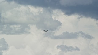 AX140_011E - 5.5K aerial stock footage of a Tecnam P2006T flying high in the clouds, Carbon County, Utah