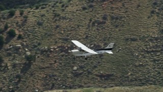 5.5K aerial stock footage of a Cessna in flight over desert mountains, Carbon County, Utah Aerial Stock Footage | AX140_017E