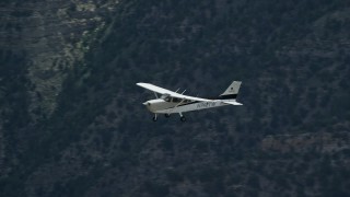 5.5K aerial stock footage of Cessna over desert mountains and mountain road, Carbon County, Utah Aerial Stock Footage | AX140_021E