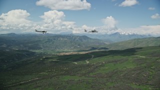 5.5K aerial stock footage of aTecnam P2006T and Cessna over mountains near winding road, Wasatch Range, Utah Aerial Stock Footage | AX140_083