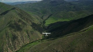 5.5K aerial stock footage of following a Tecnam P2006T over green mountain ridges, Wasatch Range, Utah Aerial Stock Footage | AX140_132