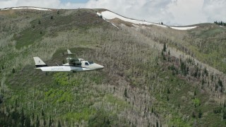 5.5K aerial stock footage of aTecnam P2006T passing by green and purple mountains, aspen trees in the Wasatch Range, Utah Aerial Stock Footage | AX140_147