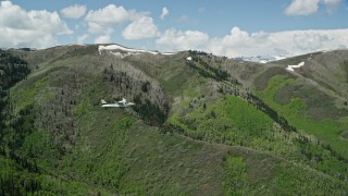 5.5K aerial stock footage tracking Tecnam P2006T airplane flying by green and purple mountains, aspen trees, Wasatch Range, Utah Aerial Stock Footage | AX140_148E