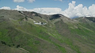 5.5K aerial stock footage fly beside a Tecnam P2006T passing green mountains, Wasatch Range, Utah Aerial Stock Footage | AX140_151E