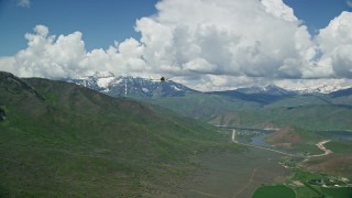 AX140_159 - 5.5K aerial stock footage track a Tecnam P2006T near Deer Creek Reservoir, snowy Mount Timpanogos, Utah