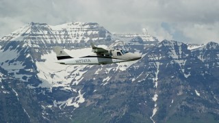 5.5K aerial stock footage of tracking a Tecnam P2006T flying by snow-capped Mount Timpanogos, Utah Aerial Stock Footage | AX140_160E