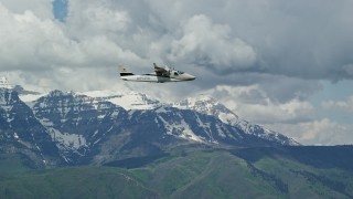 5.5K aerial stock footage of focusing on a  Tecnam P2006T passing by snow-capped Mount Timpanogos, Utah Aerial Stock Footage | AX140_165E