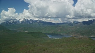 AX140_169E - 5.5K aerial stock footage of flying by Deer Creek Reservoir, snow-capped Mount Timpanogos, Utah