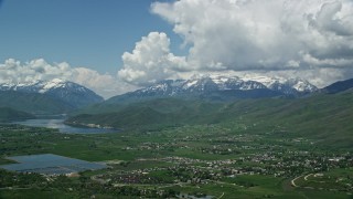 AX140_182 - 5.5K aerial stock footage of a view of snowy Mount Timpanogos, Deer Creek Reservoir, seen from Midway, Utah