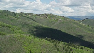 AX140_194E - 5.5K aerial stock footage of flying by upscale mountaintop homes, Deer Valley, Utah