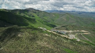 AX140_212E - 5.5K aerial stock footage of approaching and flyover of Olympic Park, Utah Olympic Park