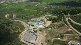 AX140_222 - 5.5K aerial stock footage of flying away from aerials pool at Utah Olympic Park