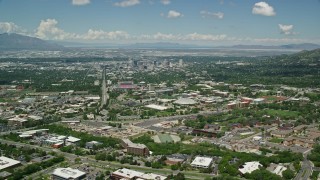 AX140_247E - 5.5K aerial stock footage fly over University of Utah, Jon M. Huntsman Center to approach Downtown Salt Lake City, Utah