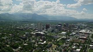 5.5K aerial stock footage of flying by downtown, Wasatch Range in distance, Downtown Salt Lake City, Utah Aerial Stock Footage | AX140_257E