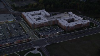 5.5K aerial stock footage flying by a large apartment building, Westwood, Massachusetts, twilight Aerial Stock Footage | AX141_003