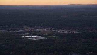 5.5K aerial stock footage flying by shopping center, trees, Dedham, Massachusetts, twilight Aerial Stock Footage | AX141_004