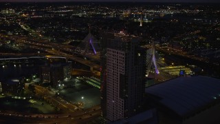 AX141_061E - 5.5K aerial stock footage approaching Avalon North Station, TD Garden, and Zakim Bridge, Downtown Boston, Massachusetts, night