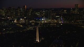 AX141_070E - 5.5K aerial stock footage orbiting Bunker Hill Monument, Zakim Bridge, and Boston skyline seen from Charlestown, Massachusetts, twilight