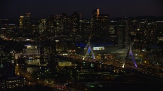 AX141_072E - 5.5K aerial stock footage approaching Zakim Bridge, TD Garden, Downtown Boston, Massachusetts, night