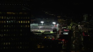 5.5K aerial stock footage flying by baseball game, Fenway Park, eclipsed by Prudential Tower, Boston, Massachusetts, night Aerial Stock Footage | AX141_079E