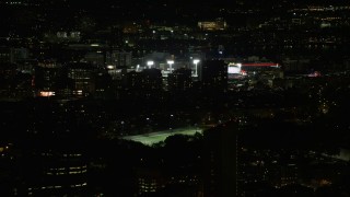 5.5K aerial stock footage flying by buildings, skyscrapers, baseball game at Fenway Park, Boston, Massachusetts, night Aerial Stock Footage | AX141_134