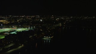 AX141_161 - 5.5K aerial stock footage flying by sports fields, Massachusetts Institute of Technology, Cambridge, Massachusetts, night