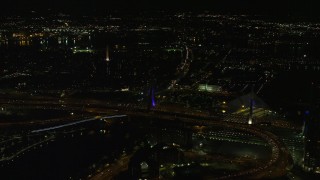 AX141_199E - 5.5K aerial stock footage flying by Zakim Bridge, approach Bunker Hill Monument, Charlestown, Massachusetts, night