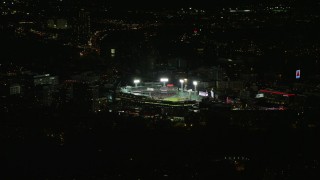 AX141_243E - 5.5K aerial stock footage flying by baseball game in progress, Fenway Park, Boston, Massachusetts, night