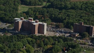 AX142_013E - 5.5K aerial stock footage approaching Lemuel Shattuck Hospital, autumn, Jamaica Plain, Massachusetts