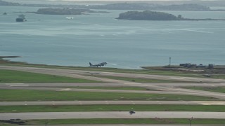 5.5K aerial stock footage tracking plane taking off, Logan International Airport, Boston, Massachusetts Aerial Stock Footage | AX142_031E