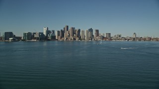 5.5K aerial stock footage flying over Boston Harbor, by skyline, Downtown Boston, Massachusetts Aerial Stock Footage | AX142_034E