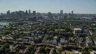 AX142_194E - 5.5K aerial stock footage over Bunker Hill Monument toward Downtown skyline, Charlestown, Massachusetts