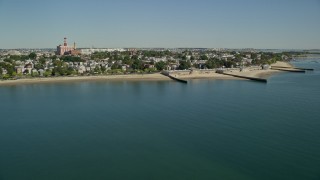 AX142_208E - 5.5K aerial stock footage flying by coastal community, South Boston, Massachusetts