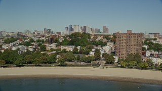 AX142_225E - 5.5K aerial stock footage of Dorchester Heights Monument, South Boston, Downtown Boston, Massachusetts