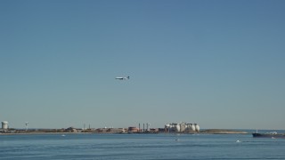 5.5K aerial stock footage tracking a commercial plane flying over Boston Harbor, Massachusetts Aerial Stock Footage | AX142_249