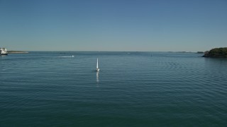 AX142_250 - 5.5K aerial stock footage tracking a sailing boat in Boston Harbor, Massachusetts