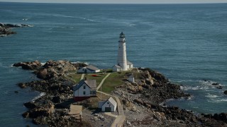 5.5K aerial stock footage orbiting Boston Light, Little Brewster Island, Boston Harbor, Massachusetts Aerial Stock Footage | AX142_261E