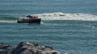 AX142_270 - 5.5K aerial stock footage tracking lobster fishing boat by rock formations, Boston Harbor, Massachusetts